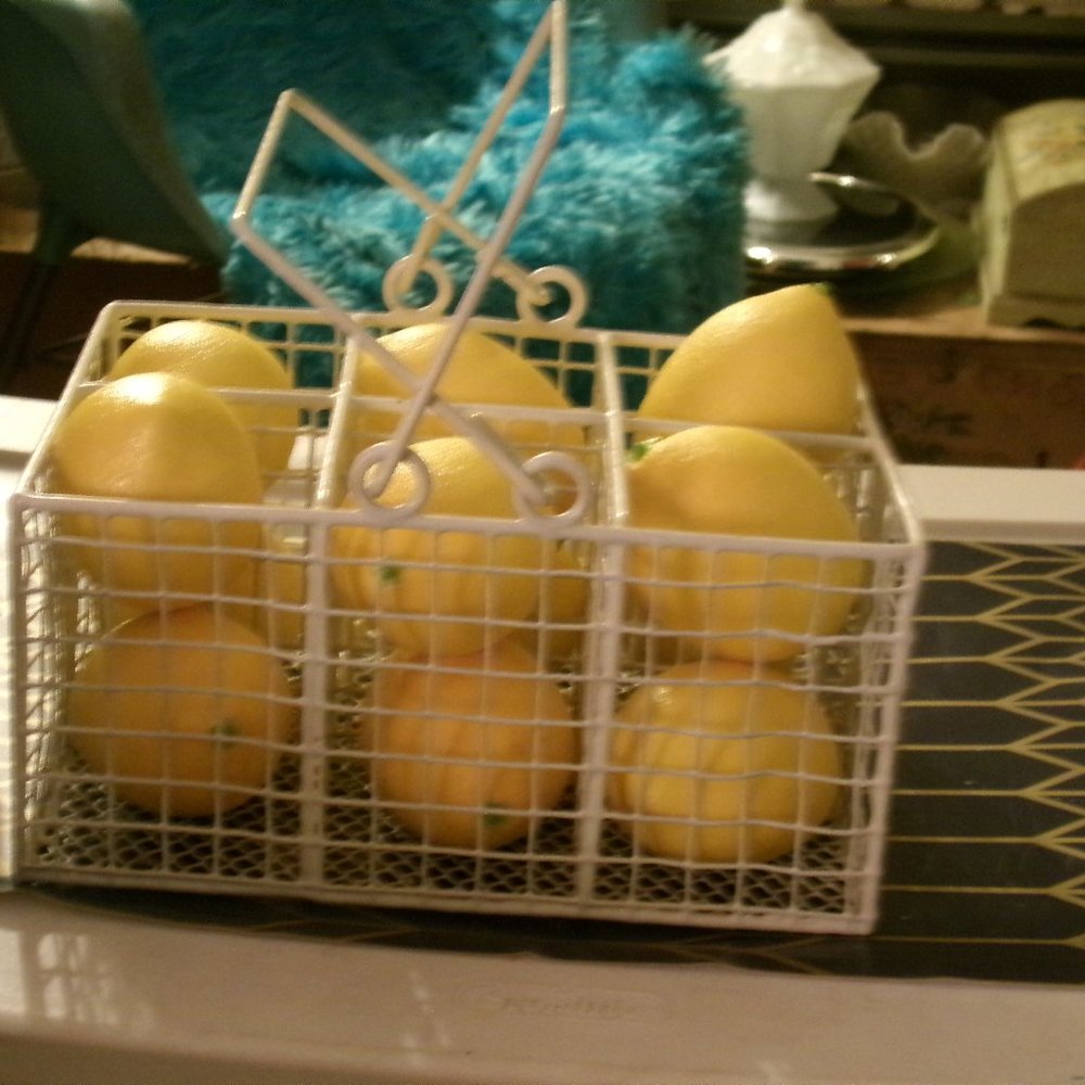 wire basket with 12 plastic realistic lemons.